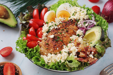 A bowl with cobb salad, traditional American dish