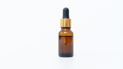 Amber glass dropper bottle with gold cap, isolated on white background, ideal for essential oils or cosmetic product mock up with copy space
