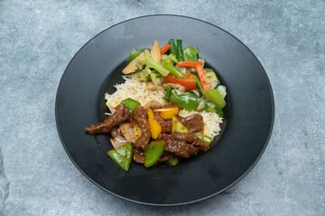 Beef Stir fry and Mixed Vegetables with Fried Rice on a Plate side view of japanese food