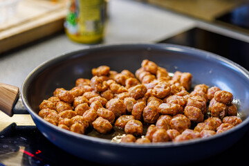 Delicious meatballs sizzle in a pan, ready for a savory Italian feast