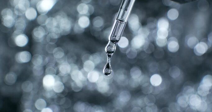 Slow Motion of Crystal Clear Serum Drop Dripping from Glass Pipette at 1000fps  Transparent Beauty Essence, Facial Care Serum, Luxury Skincare Product, Minimalist Background, Cosmetic Detail