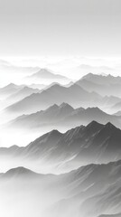 Misty mountain range in black and white with layers of fog