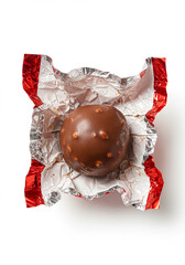 Chocolate ball candy in a partially opened red foil wrapper.