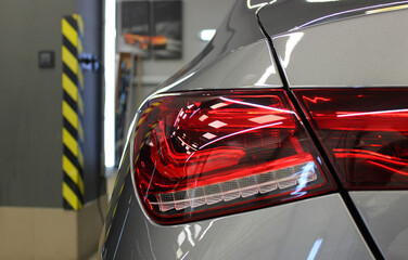 Interesting design of a rear light with LED elements of a car in tuning studio   © AnyVIDStudio