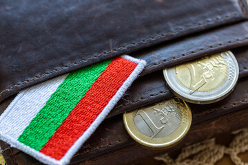 Euro coins falling out of a wallet with the Bulgarian flag. A financial and business concept. Bulgaria entry into the Eurozone.