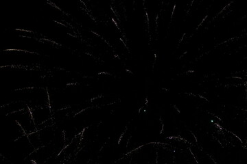 Obraz premium Fireworks on the dark sky background. Colorful fireworks. Abstract colored firework background with free space for text. fireworks light up the night sky. New year celebration fireworks 