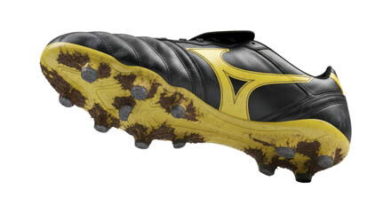 Black and yellow soccer cleat with muddy studs on transparent background