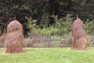 Hay stacks and garden flowers
