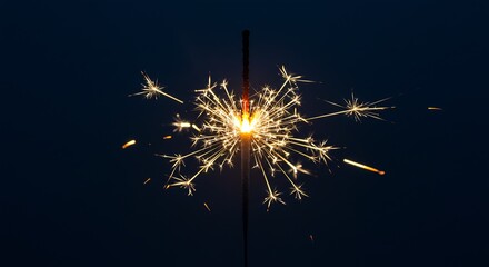 Celebrate the new year with a vibrant sparkler against a dark sky, perfect for adding festive cheer and a touch of magic to your holiday designs