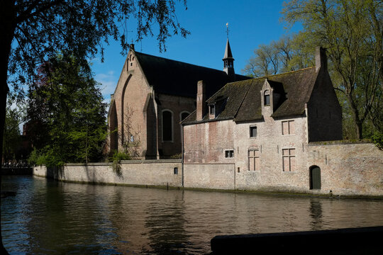 Bruge, Belgium, Europe Beautiful small brick chapel along the river.