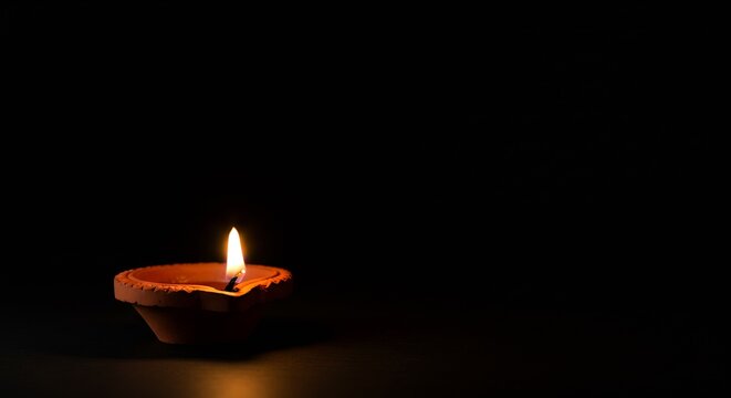 Warm candle flame glowing in the darkness creates a peaceful, serene mood, perfect for meditation or spiritual guidance with soft lighting - Powered by Adobe