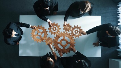 Top view of professional business team bring filled last cog to complete system. Group of smart...