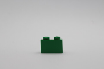 Naklejka premium Green Lego brick piece isolated on a white background 