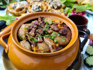 Hot potato pancakes in a yellow clay pot