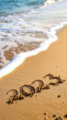 The year 2023 written in the sand on a beach, with waves lapping at the shore