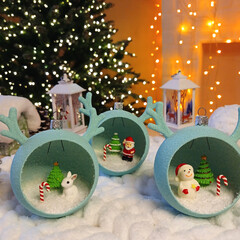 New Year's toys in the form of a ball with horns with small miniatures inside. decorative gift balloons to decorate your home, office or as a gift. Christmas tree, Santa Claus, snowman and hare