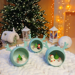 New Year's toys in the form of a ball with horns with small miniatures inside. decorative gift balloons to decorate your home, office or as a gift. Christmas tree, Santa Claus, snowman and hare