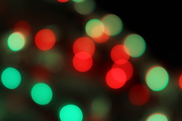 Obraz premium Christmas lights in bokeh. Red and green Christmas lights bokeh background wallpaper. Abstract blurred bokeh Christmas background. Xmas backdrop, Bokeh abstract wallpaper