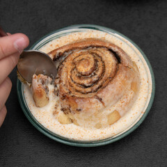 Chocolate dessert on plate served with hand holding fork.