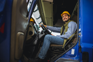 Young truck driver in truck cabin