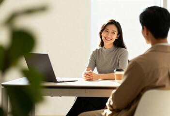 Obraz premium Smiling woman having meeting with colleague in bright modern office 