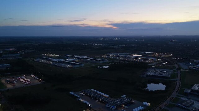 Aerial night view of illuminated Meta data center at sunset.