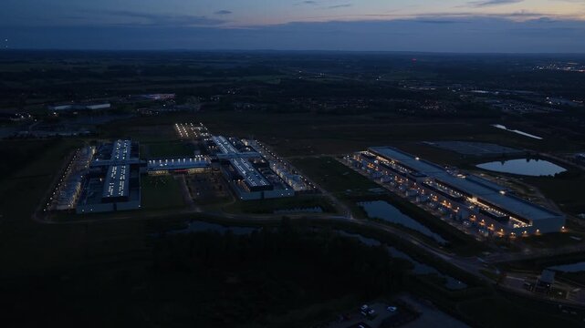 Meta data hub glowing after sunset, aerial drone photo.