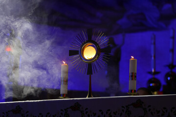 Sacred objects on the altar in a church at night with candles