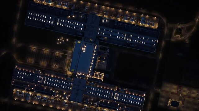 Illuminated data center and high-tech servers in Odense at night.