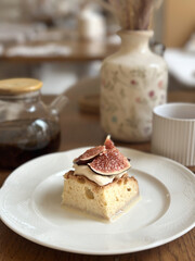 Cozy Tea Time with Fig Pie Slice on White Plate