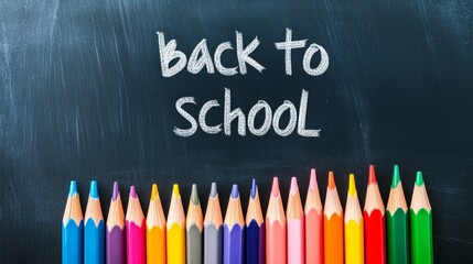 Colorful pencils are lined up at the bottom of a blackboard with the words back to school written in chalk, creating a vibrant and exciting image representing the start of a new academic year