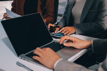 Obraz premium Accounting company provide finance and taxation planning for profitable cash flow, Auditor and accountant team working in office, analyze financial data and accounting record with calculator.Insight