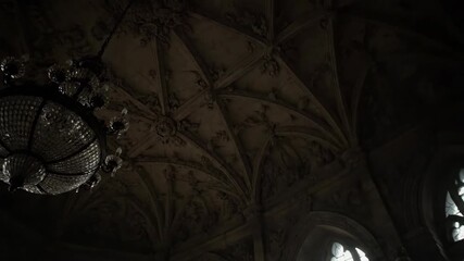 Interior shot of a room with chandelier, vaulted ceiling, and windows - Powered by Adobe