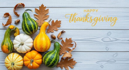 Happy thanksgiving greeting with assorted pumpkins and gourds arranged with autumn leaves on a rustic wooden background, celebrating the harvest season