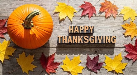 Happy thanksgiving text with a pumpkin and autumn leaves arranged on a rustic wooden background