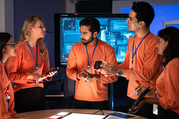 Diverse developer team having a focused business meeting in a command center. Planning and discussing digital strategy of new product development. Review user interface experience, UX and UI design
