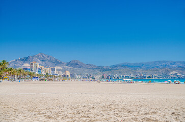 Playa de San Juan beach in Alicante city Campello town, Muchavista sandy beach of Mediterranean Sea coast Costa Blanca coastline in sunny summer day, mountain range, Valencian Community, Spain