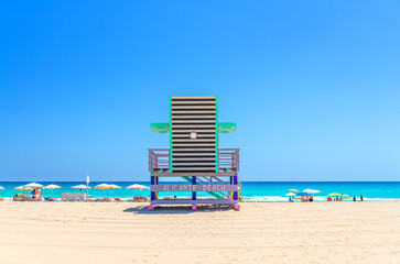 Playa de San Juan beach in Alicante city, colorful Lifeguard Hut Lifeguard Tower on sandy beach of Mediterranean Sea coast Costa Blanca coastline in sunny summer day, Valencian Community, Spain