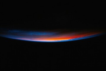 Celestial Horizon: The curvature of Earth, showcasing the vibrant colors of the sunrise, with the transition of light and darkness. This awe-inspiring view inspires wonder.