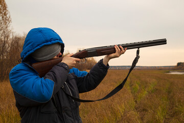 Duck hunting . A man with a gun on a duck hunt.