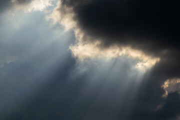 Obraz premium Sun Rays Breaking Through Storm Clouds