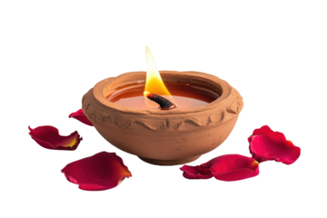 Traditional clay diya lamp glowing brightly with candle flame and rose petals scattered around during festive evening celebration