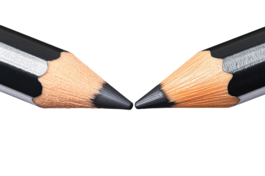 Pencils in close proximity creating a unique visual interaction that highlights their sharpened tips and contrasting colors