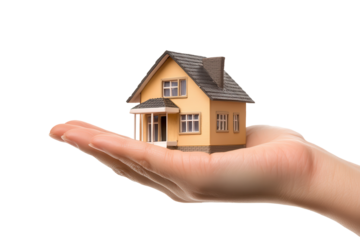 Miniature house held in hand symbolizing real estate investment and home ownership concepts