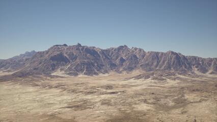 Fototapeta premium A breathtaking aerial view of a majestic mountain range in the vast, desert landscape