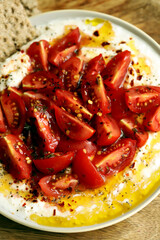 Tomatoes with white sauce and olive oil