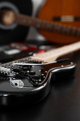 Fototapeta premium Electric guitar setup with repair tools. Electric guitar bridge adjustment with tremolo installation and setup tools nearby. Electric guitar adjustment with focus on the bridge and tuning stability.