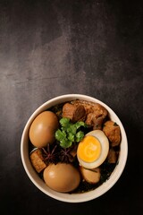Seasoned eggs, hard boiled eggs and pork belly in Chinese Five Spices Sauce,Five Spice Egg with pork, thai called kai pa lo, boiled eggs and pork in brown soup