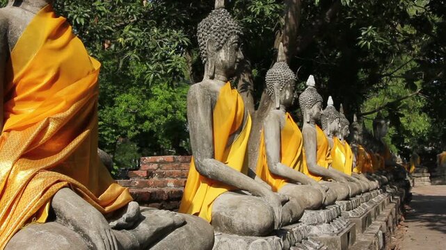 Sliding shot of a row of Buddhas at a temple in Ayutthaya Thailand