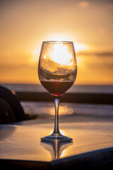 glass of red wine on a table at sunset in Punta del Este, Uruguay at golden hour